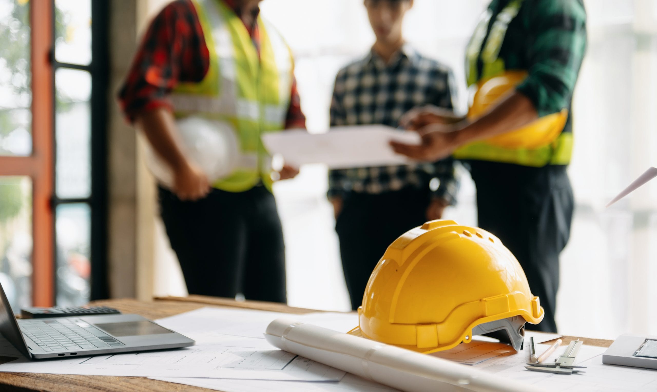 Draughtsmen reviewing technical drawings